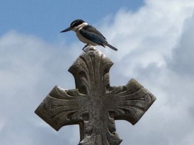 Bird on cross sculpture